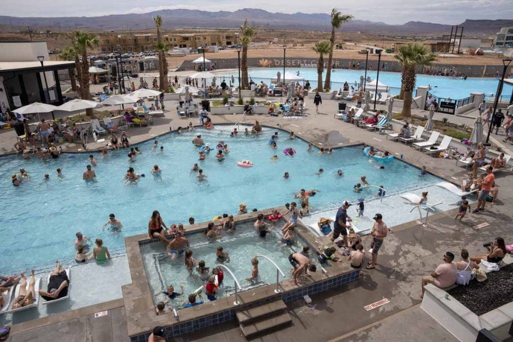 Families enjoying the Crystal Lagoon and resort pool at Desert Color in St. George, Utah — the amenity that drives vacation rental bookings